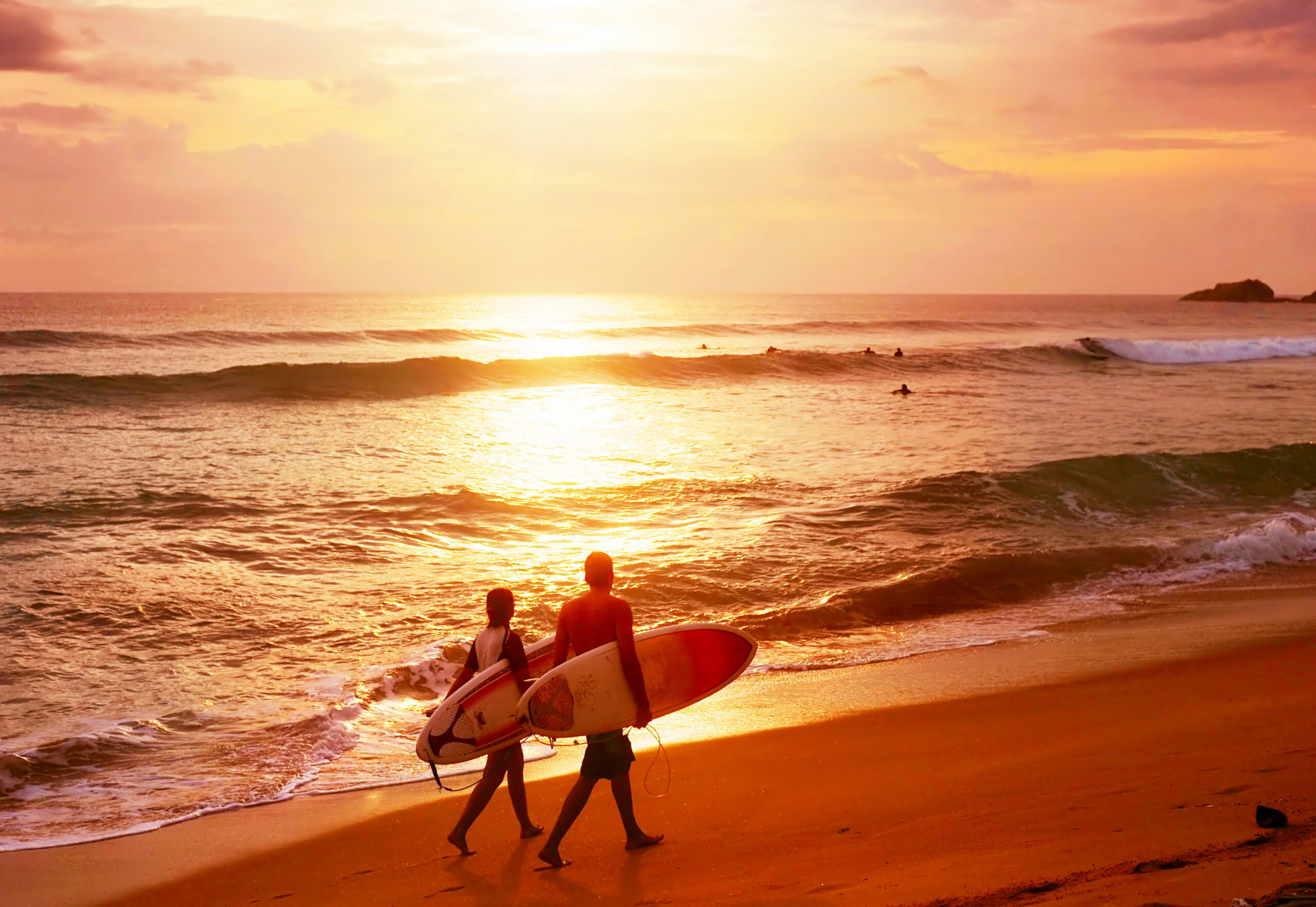 Tourists watching the sunset from Coconut Tree Hill in Mirissa, Sri Lanka